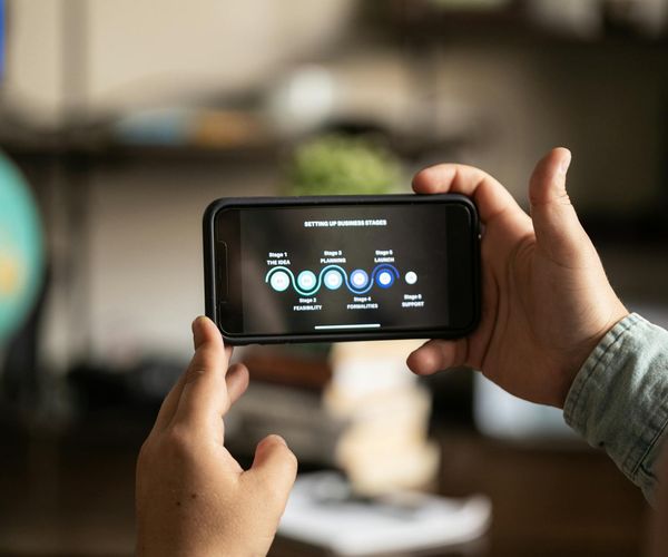 Digital interface showing progress charts and video tutorials.