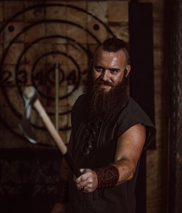 Man performing a controlled strength exercise in a dark setting.